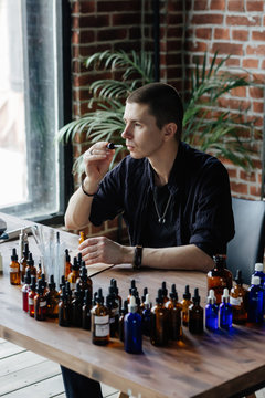 Professional man preparing perfume