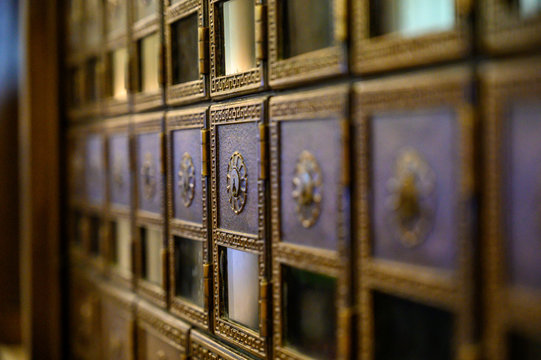 Rows of empty brass post office boxes