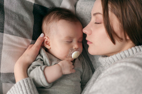 portrait of sleeping moms with a baby in an embrace