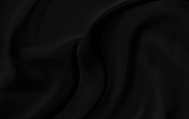Black gray satin dark fabric texture luxurious shiny that is abstract silk cloth background with patterns soft waves blur beautiful.