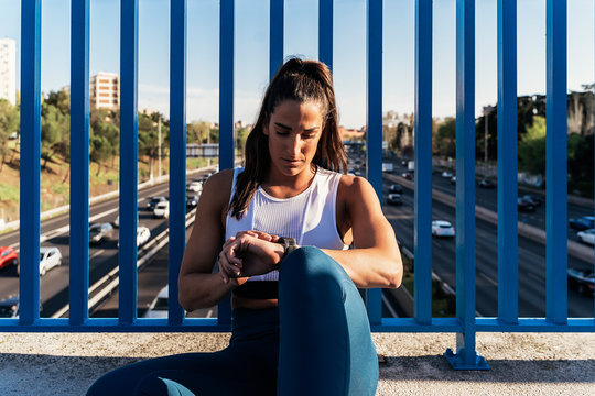 Sportswoman checking watch device