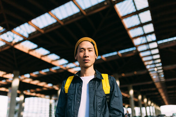 Portrait of stylish asian man looking at camera