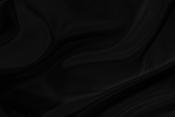 Black gray satin dark fabric texture luxurious shiny that is abstract silk cloth background with patterns soft waves blur beautiful.