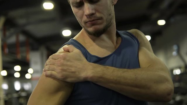 Athlete suffering from pain in shoulder, cramp during warming-up, muscle strain