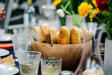 Large wooden bread bowl on dinner table