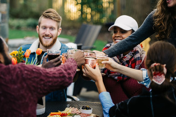 Friends toasting during an outdoor dinner party