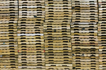 Wooden Pallets Stacked in Warehouse