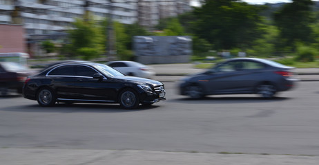 Fototapeta na wymiar black car in the city filmed in motion