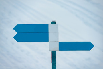 Blank direction signs in a ski resort to indicate ski runs.