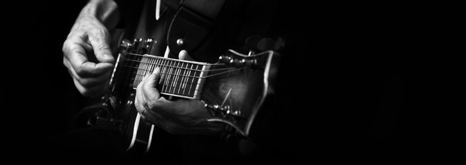 Guitarist hands and guitar close up. playing electric guitar.  black and white. copy spaces