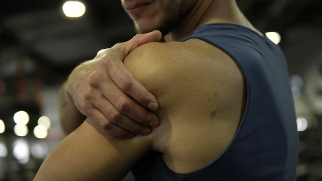 Sports man feeling pain during training, sprain, dislocation of shoulder joint