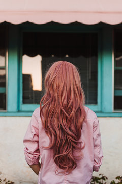 Back view of woman's beautiful pink wig