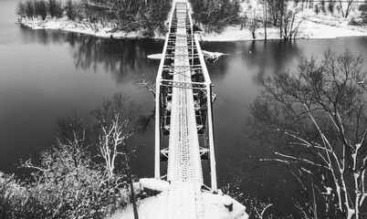 A view of an old train bridge over the White River in Indianapolis covered with snow