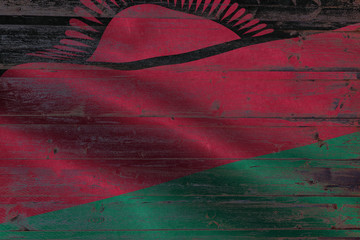 Malawi flag on an old wooden plank forming a background