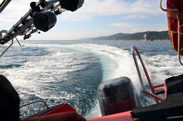 trail of a wave from a motor boat in a sharp bend