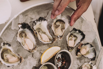 Fresh oysters close-up on plate with ice