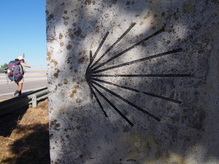 Scallop shell mark with pilgrim, Camino de Santiago, Way of St. James, Journey from Terradillos de los Templarios to Bercianos del Real Camino, French way, Spain