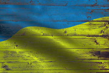 Ukraine flag on an old wooden plank forming a background