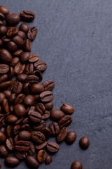 Roasted coffee beans on granite background
