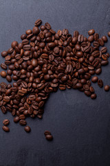 Roasted coffee beans on granite background