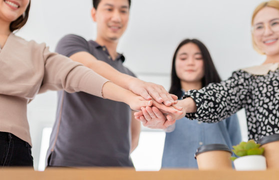 asian officer team holding hand together, they feeling cheerful and so happy, unity and teamwork, asian people prepare to group mission, happiness organization