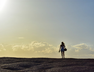 silhouette of woman on top of a mountain