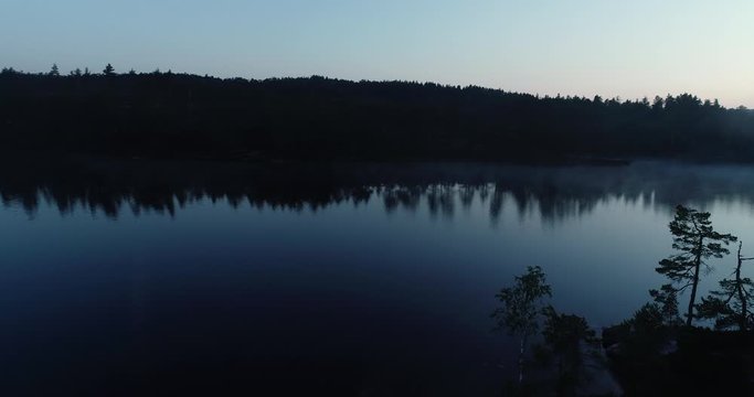 Magical foggy morning on the lake inn the forest in south Norway. Drone footage. G&aring;sefl&aring;.