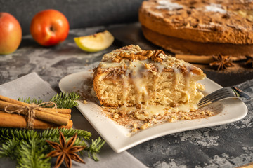Apple pie with cinnamon on the table, a piece of apple pie with condensed milk and walnuts on a...