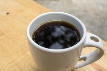 A cup of coffee on a wood table