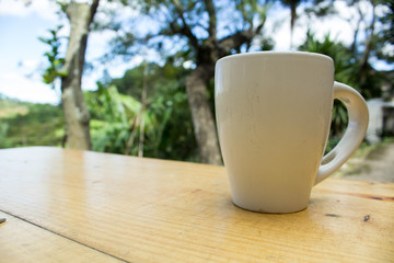 A cup of coffee on a wood table