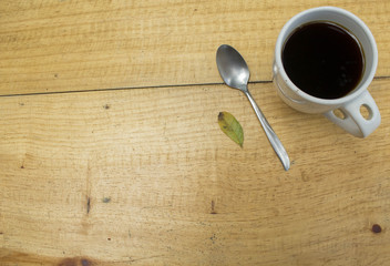 A cup of coffee on a wood table