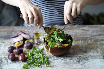 Healthy arugula plum salad. Selective focus. Macro.