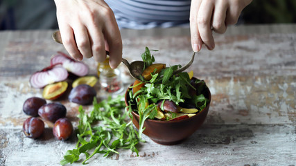 Healthy arugula plum salad. Selective focus. Macro.