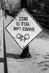 sign on road upside down shared lane yield to bikes