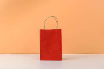 mockup of blank craft package or colorful paper shopping bag with handles