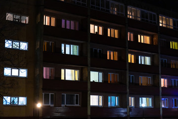 Fototapeta na wymiar light in the windows at night in an apartment building