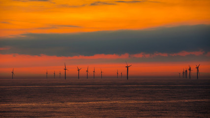 Fototapeta na wymiar wind turbines from the Northern Sea in the sunset