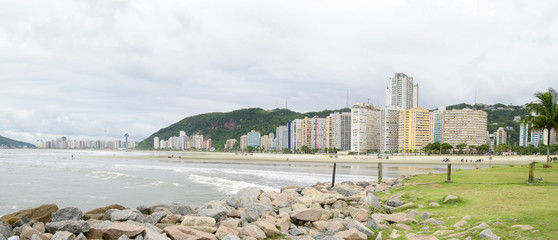 Panoramic view of a beach of Santos SP Brazil. Jose Menino beach. Beach, the sea and the city on background. Brazilian coastal city.