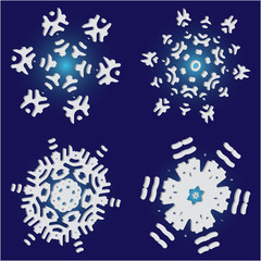 Set of christmas paper snowflakes on blue background.