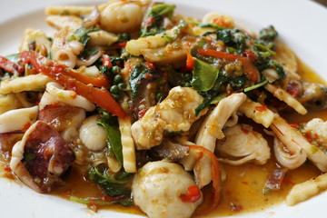 The spicy fried mixed seafood with the Thai basil leaves and herb dish.