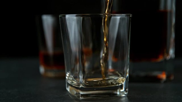Super Slow Motion Shot of Pouring Whiskey into Glass at 1000fps with Camera Movement.
