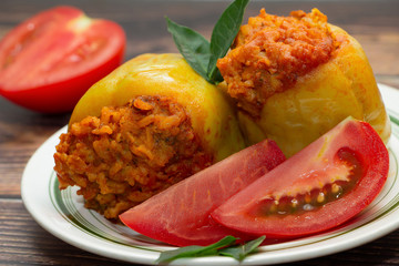 Stuffed peppers with vegetables on a wooden background