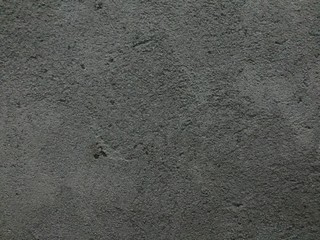 Dark wall abstract texture from cement with stone for background. Home construction from Indonesia, Asia.