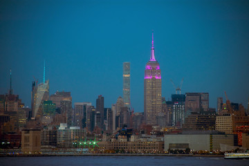 A night view of NYC's midtown Manhattan skyline, including the Empire Stete Building, from across the Hudson River, at Liberty State Park, New Jersey