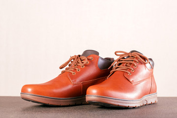 Modern elegance men's boots shoes on floor with place for text.