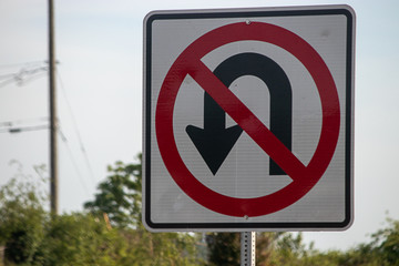 no u-turn sign attached to a metal pole