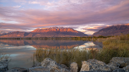 Mountain reflection during colorful sunset looking at Timpanogos mountain from across Utah Lake.