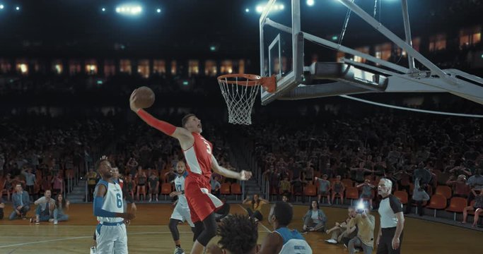 Basketball players on big professional arena during the game. Tense moment of the game. Celebration