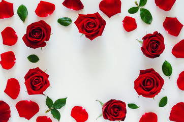 Red roses with its petals and leaves put on white background with heart shape space for Valentine’s day. Flat lay background concept.