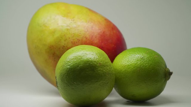 Ripe Mango And Limes - A Perfect Combination Of Sweet And Sour Fruits - Close Up Shot
